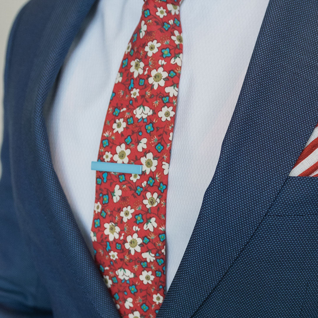 Sky Blue Tie Bar over red floral tie