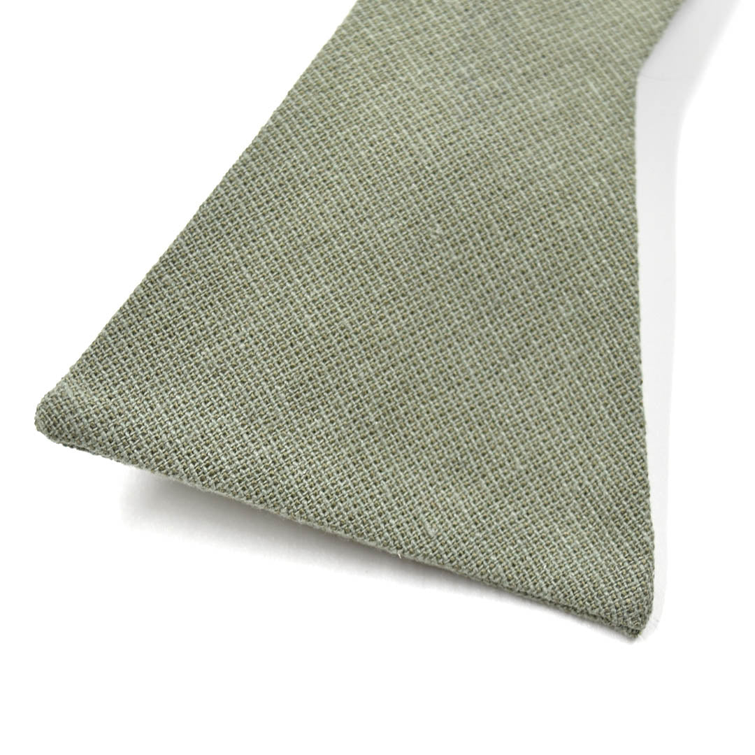 Close-up of a textured green fabric triangle on a white background