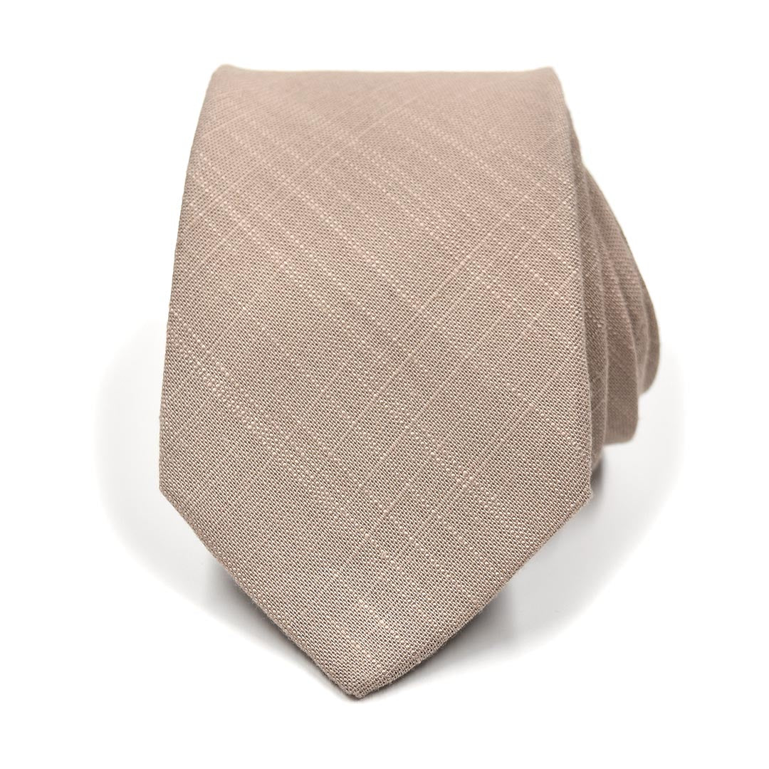 Beige tie with a subtle pattern on a white background