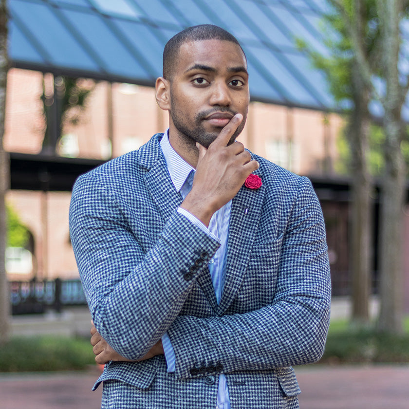 city boy with finger near mouth