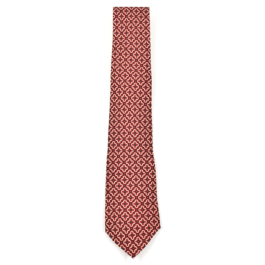 Red patterned tie on a white background