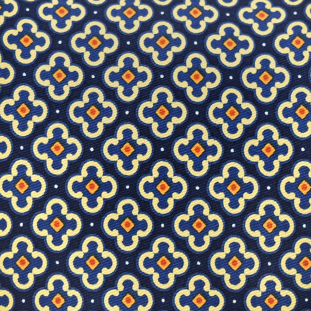 Patterned fabric with blue, yellow, and orange design on a blue background