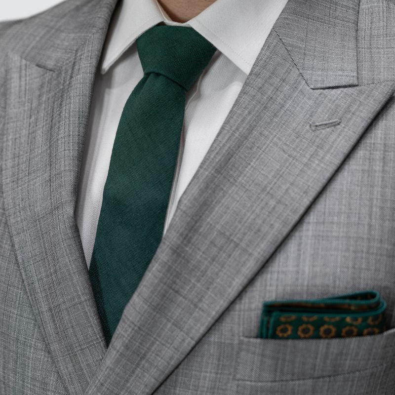 Gray suit with a green tie and pocket square