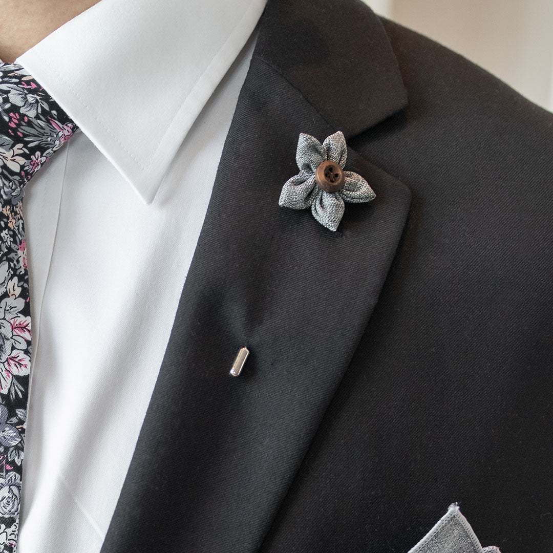 Wildflower Grey Lapel Pin on a black suit lapel