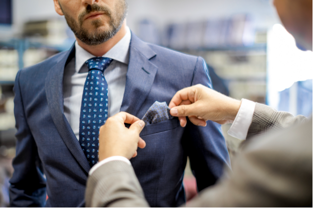 A man fixing a pocket square