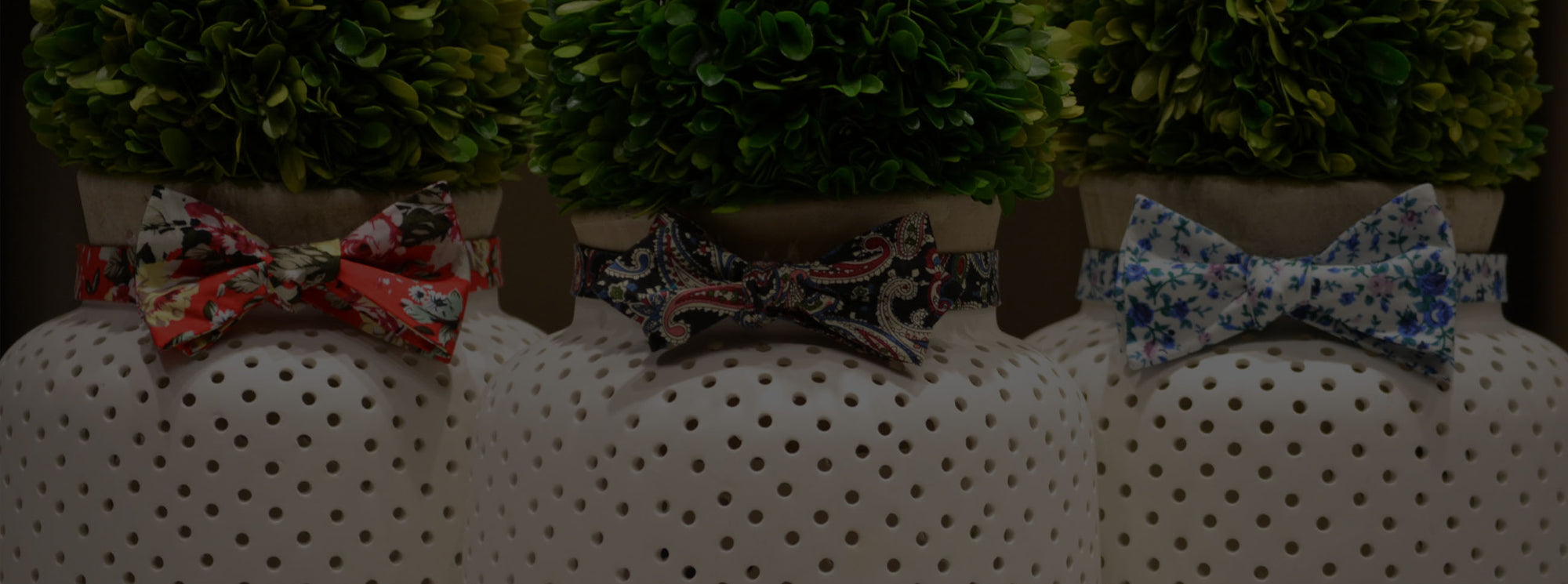 three different floral bow ties around plant vase