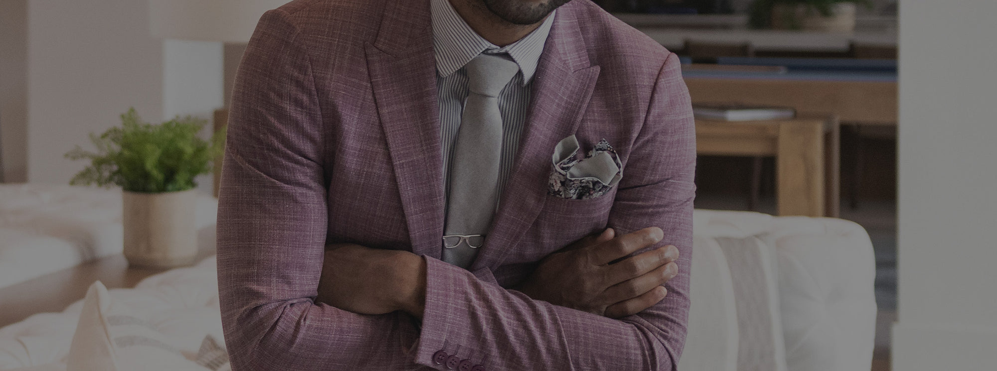 Man wearing a grey tie and a lavender suit