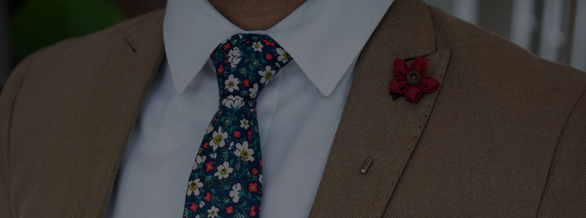Brown suit with red lapel pin