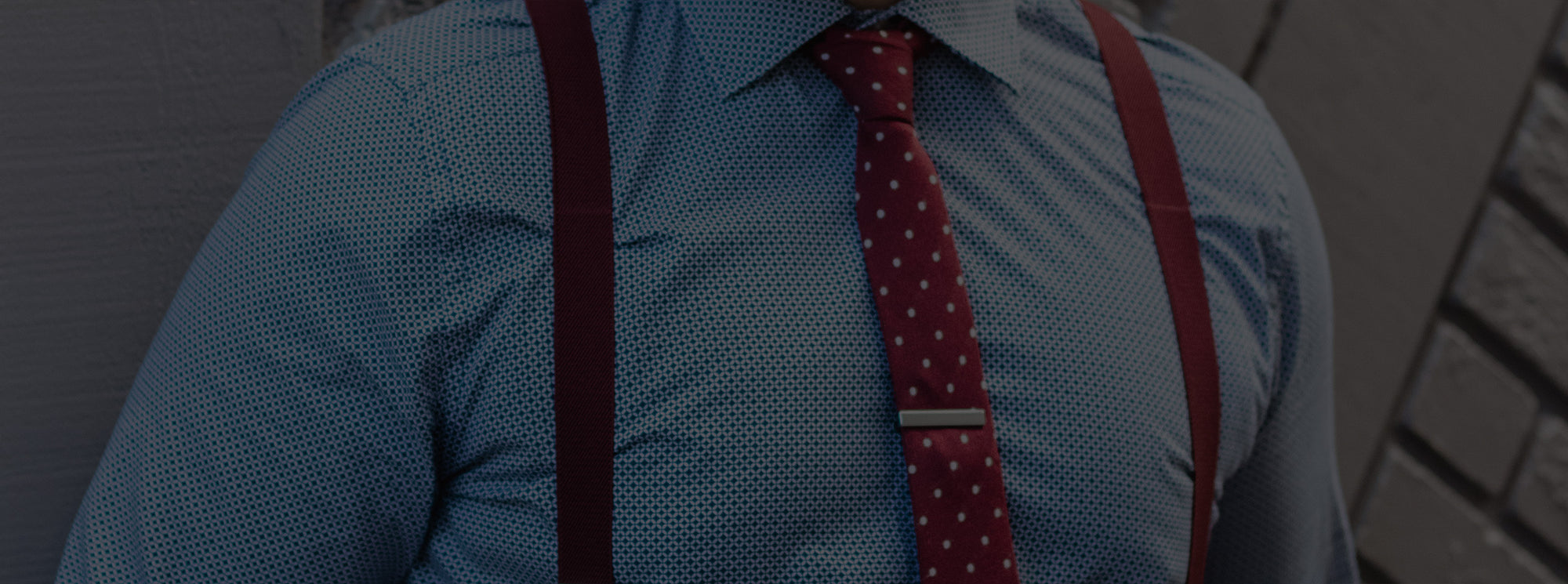 Man wearing a red polka dot tie with suspenders