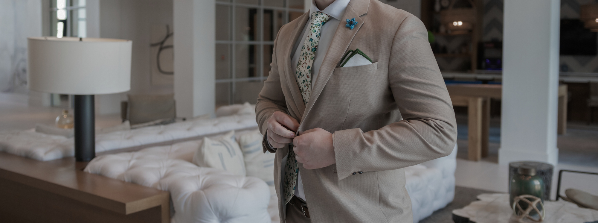 a gentleman standing in a beige suit