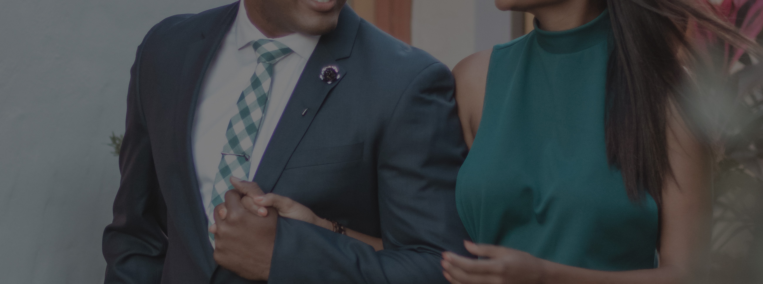 date night man and woman holding hands dressed up wearing a suit and tie