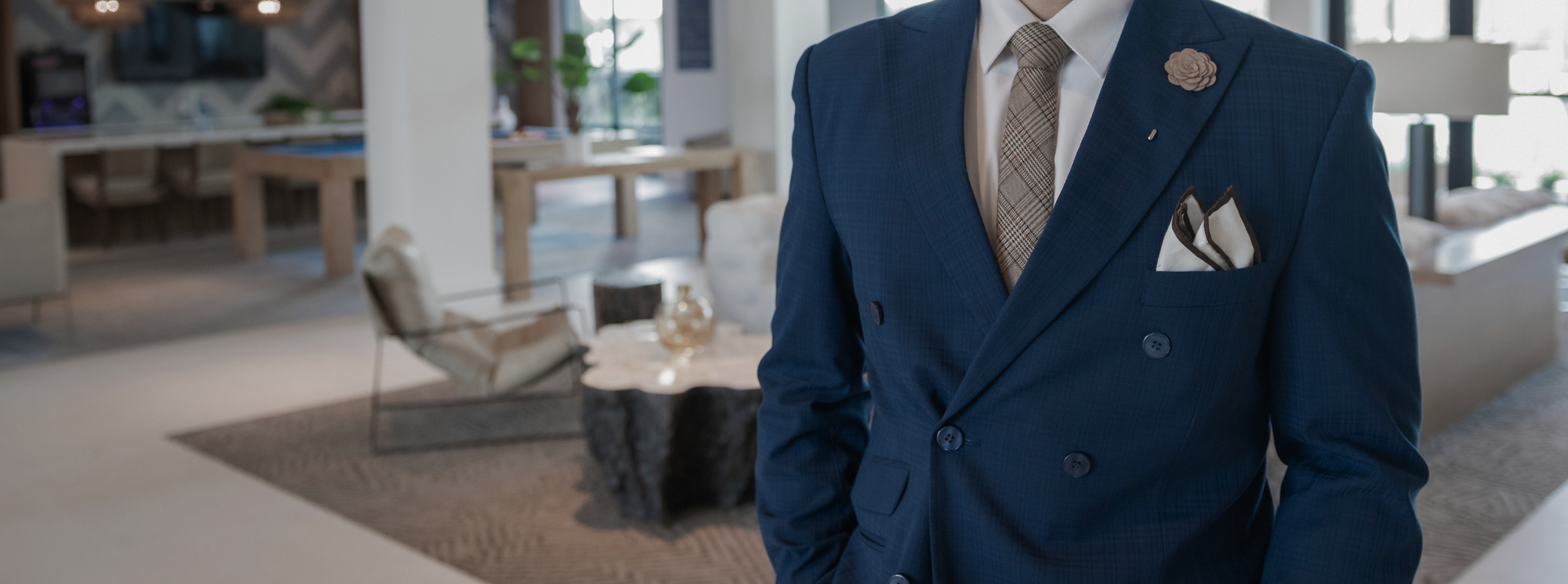 a gentleman standing in a navy blue suit