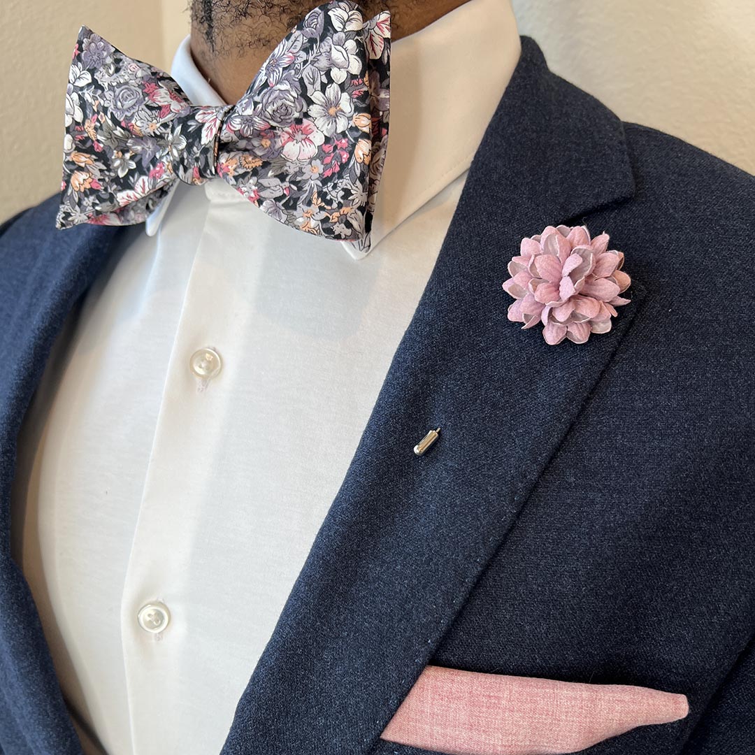 Man wearing navy suit with Floral Black Bow Tie Set