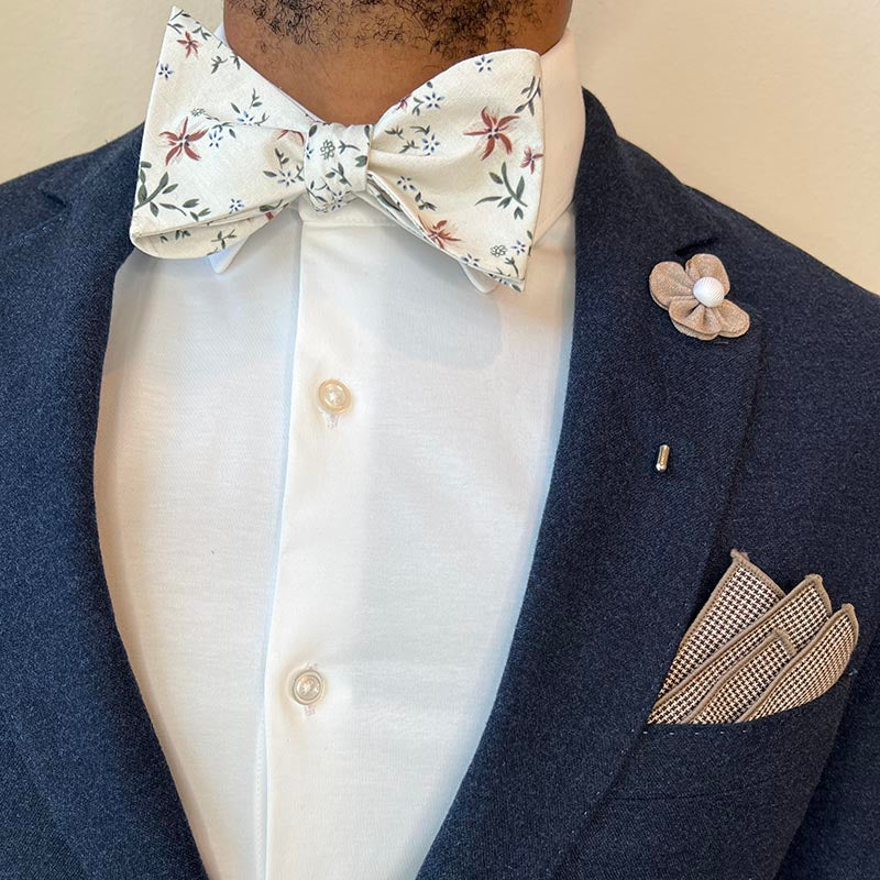 Man wearing Floral Bow Tie with a navy suit and a white shirt