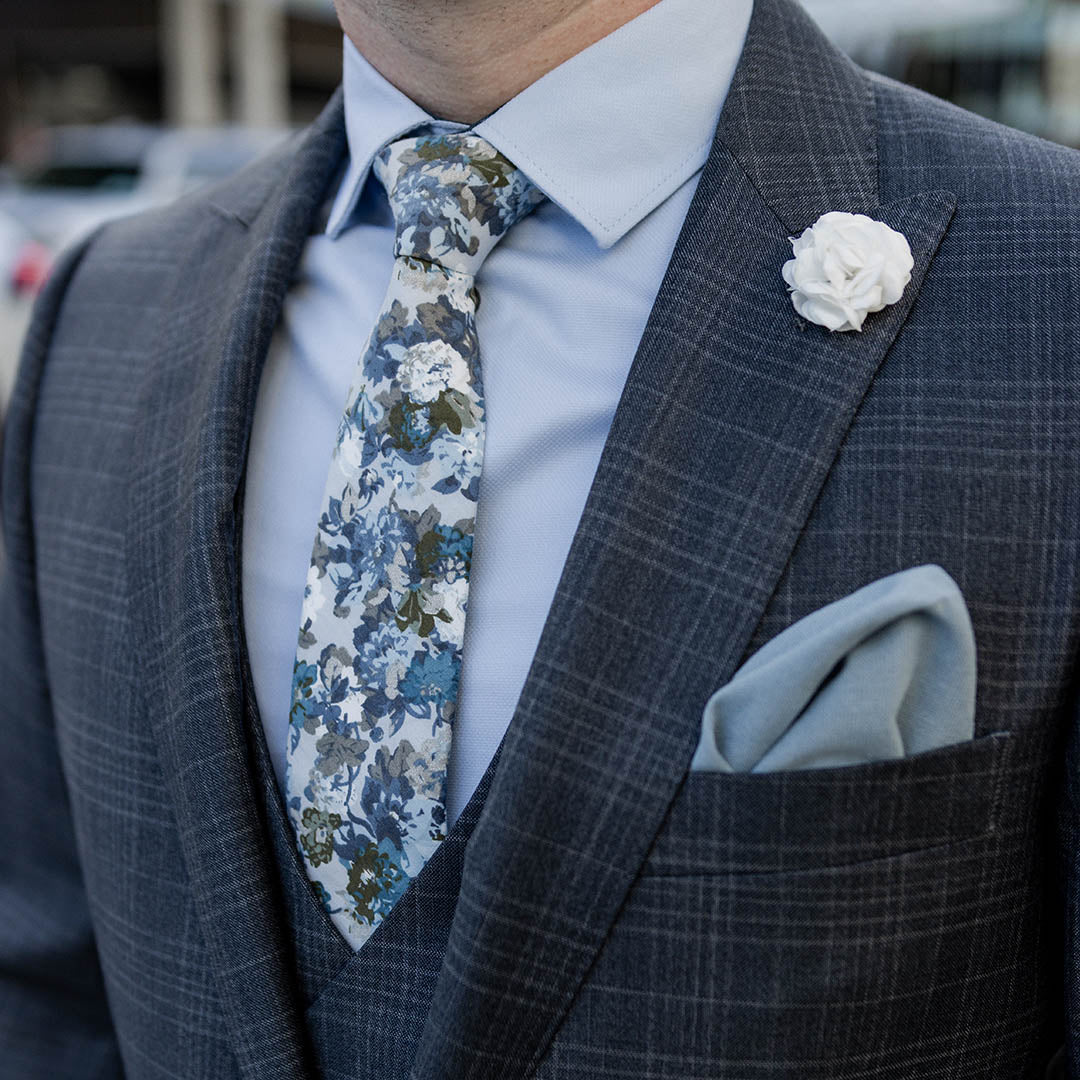 Charcoal plaid suit with blue shirt and floral blue tie