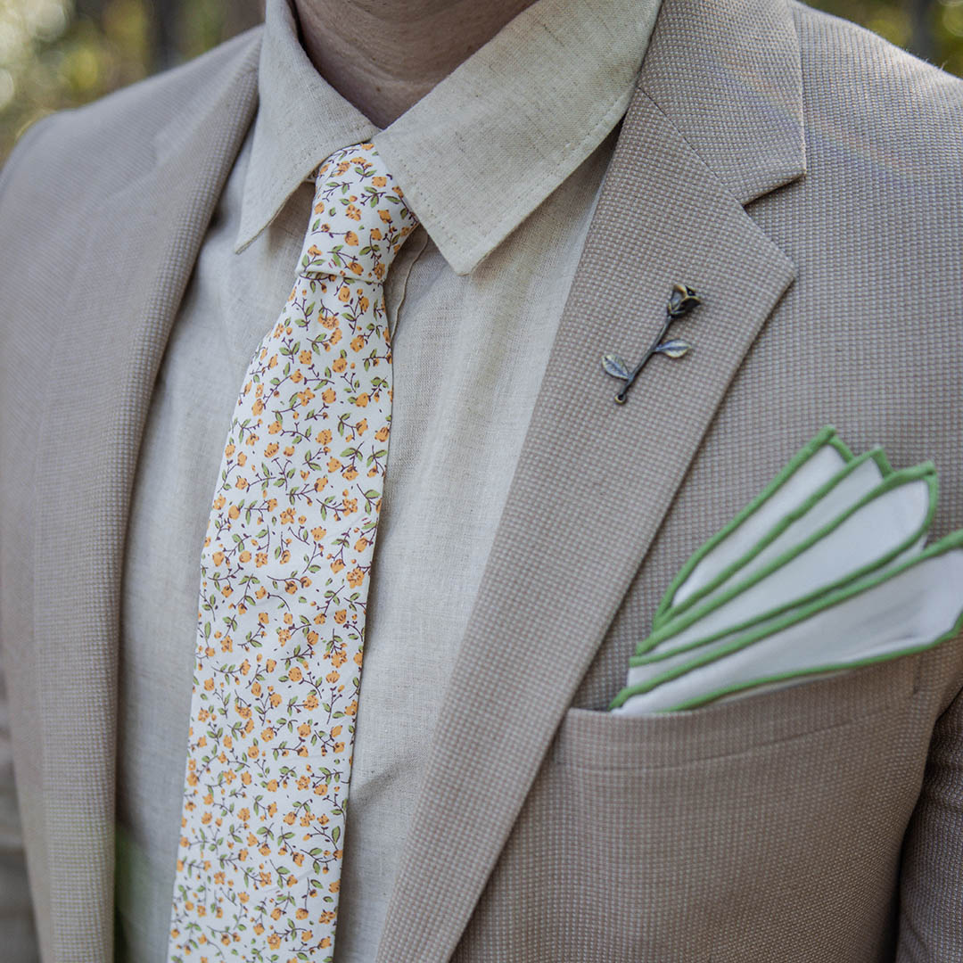 Tan suit with Floral marigold yellow wedding tie and a linen shirt