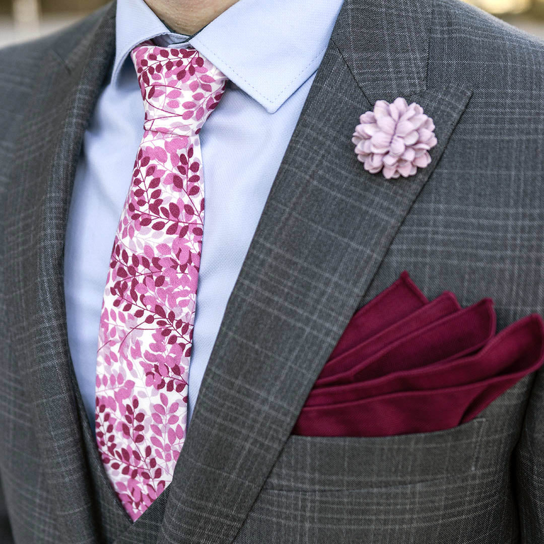 grey plaid business suit with a blue shirt, mauve and burgundy floral tie