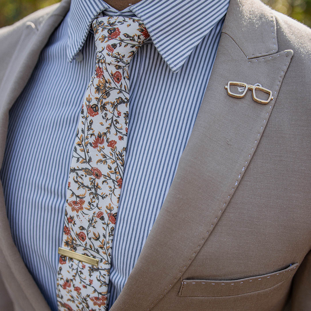 Tan suit with a striped Blue shirt and Floral Cream and Rust Tie