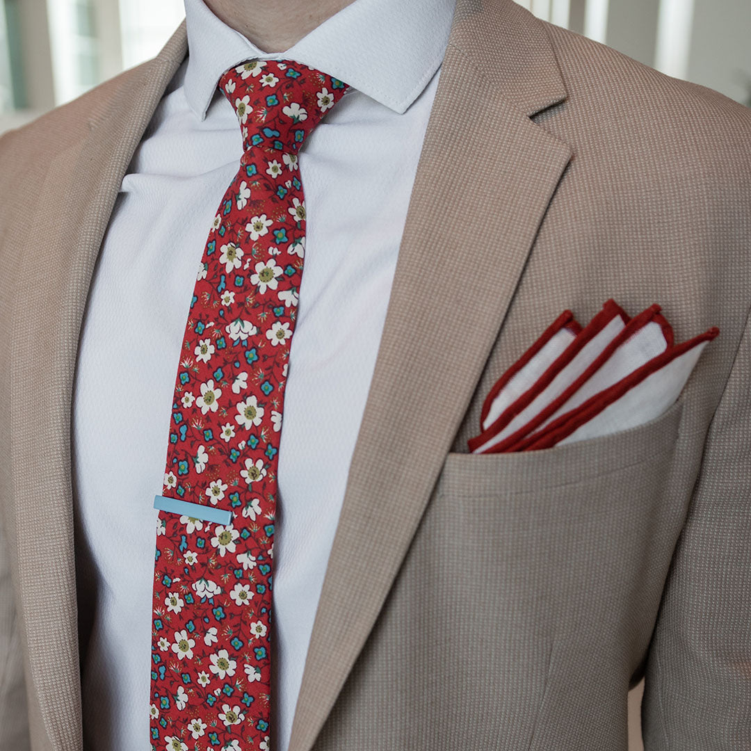 Floral ruby blooms tie set over a tan suit