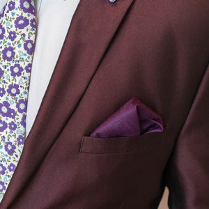 Plum herringbone pocket square in a burgundy suit pocket