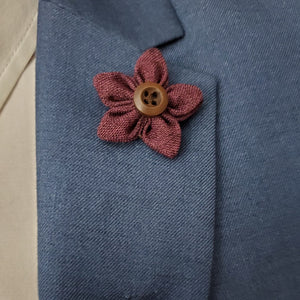 Lapel pin wildflower burgundy on a blue suit 