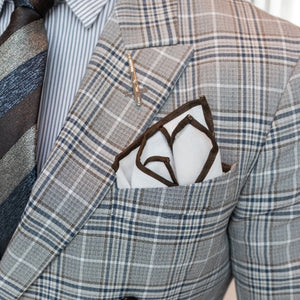 Man wearing a suit with brown border linen pocket square