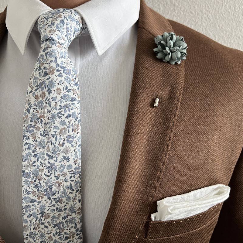 floral misty blue small print tie rolled up