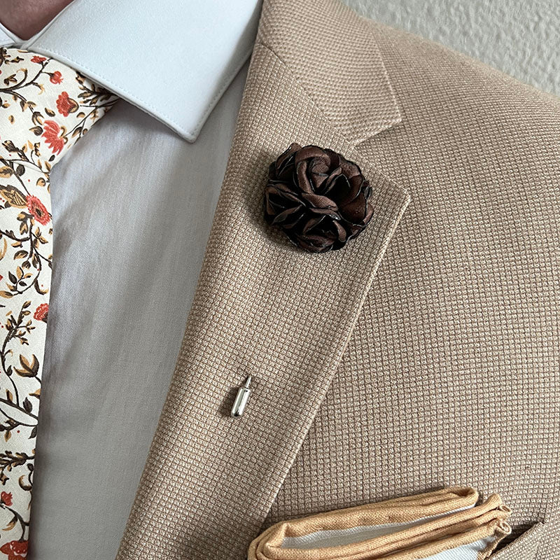 Brown Rose Floral Lapel Pin with a Tan Suit