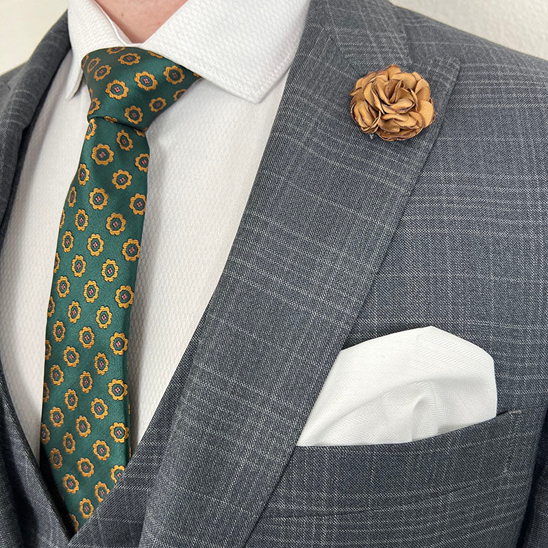 Rose Light Brown Lapel Pin paired to a Charcoal Grey suit and Green Tie