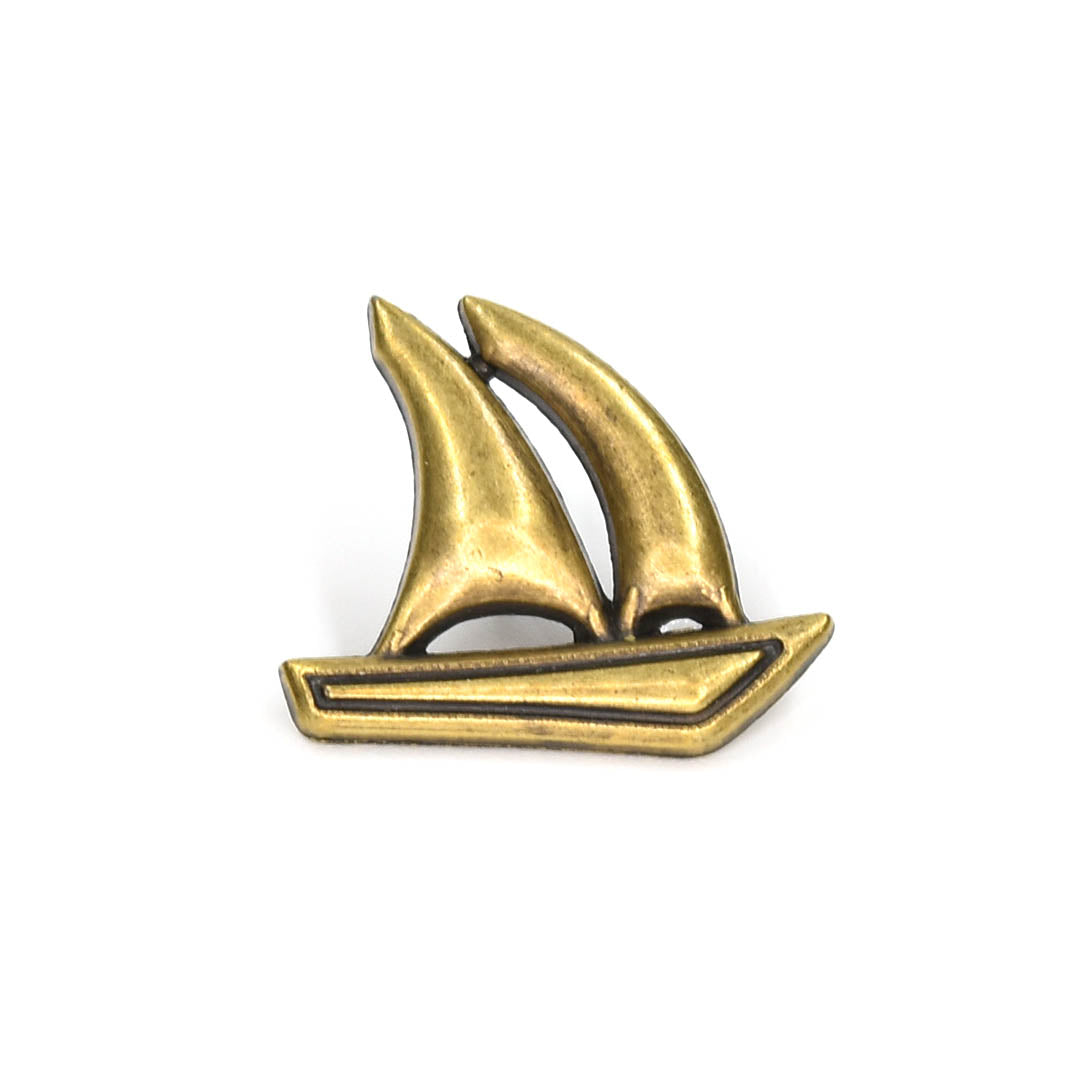 Bronze Sailboat shaped lapel pin on a white background
