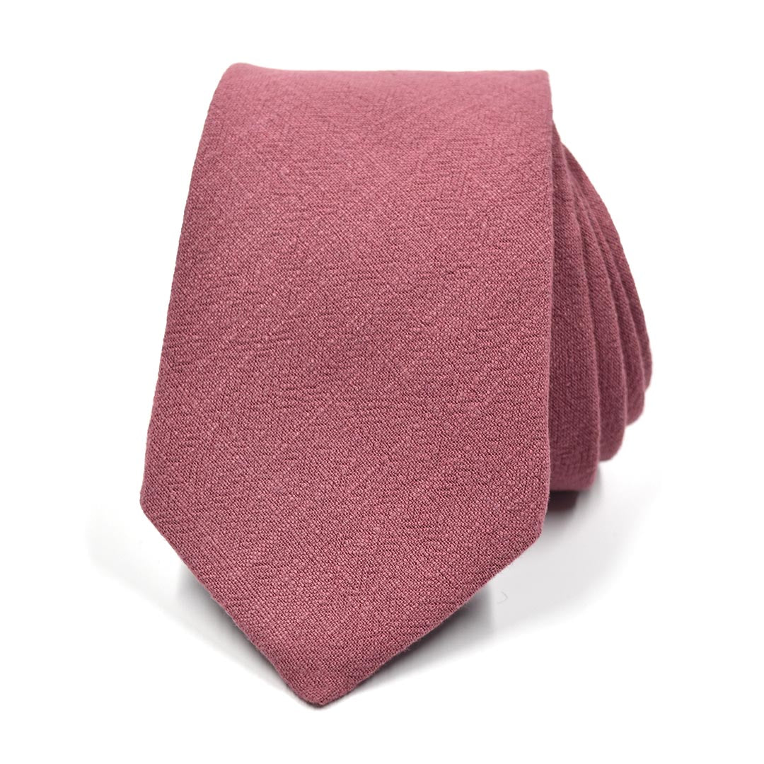 Pink textured tie on a white background
