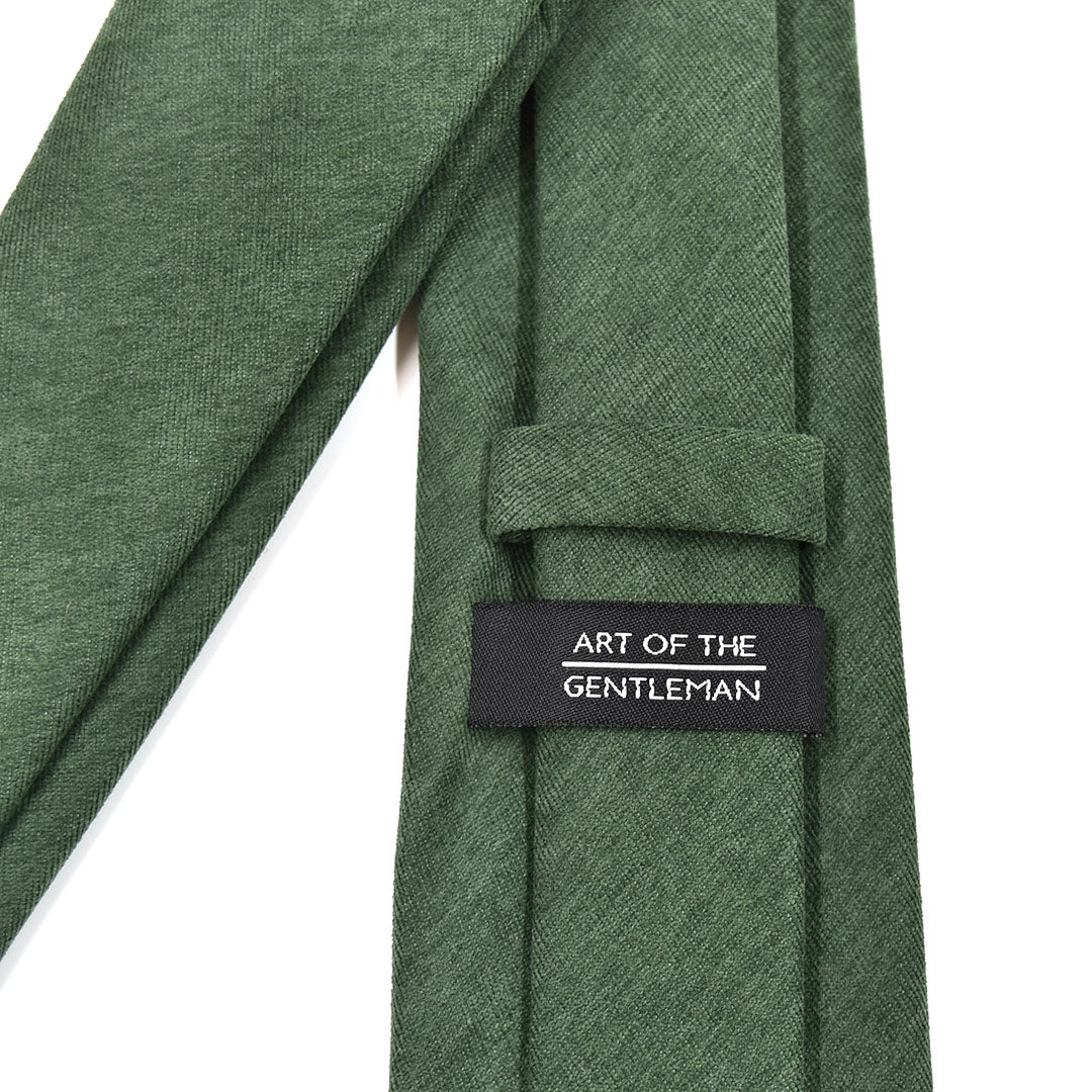 Hunter Green tie with a label reading 'Art of the Gentleman' on a white background