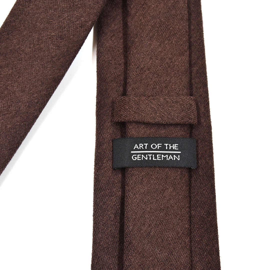 Mocha Brown tie with a label reading 'Art of the Gentleman' on a white background