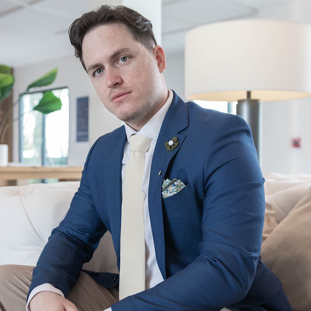 Microsuede Canary Ivory Tie in a blue suit