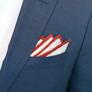 Floral red border pocket square in a navy suit pocket