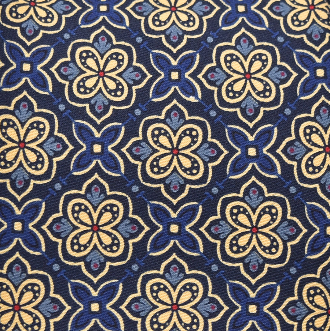 Patterned fabric with blue and beige flowers on a blue background