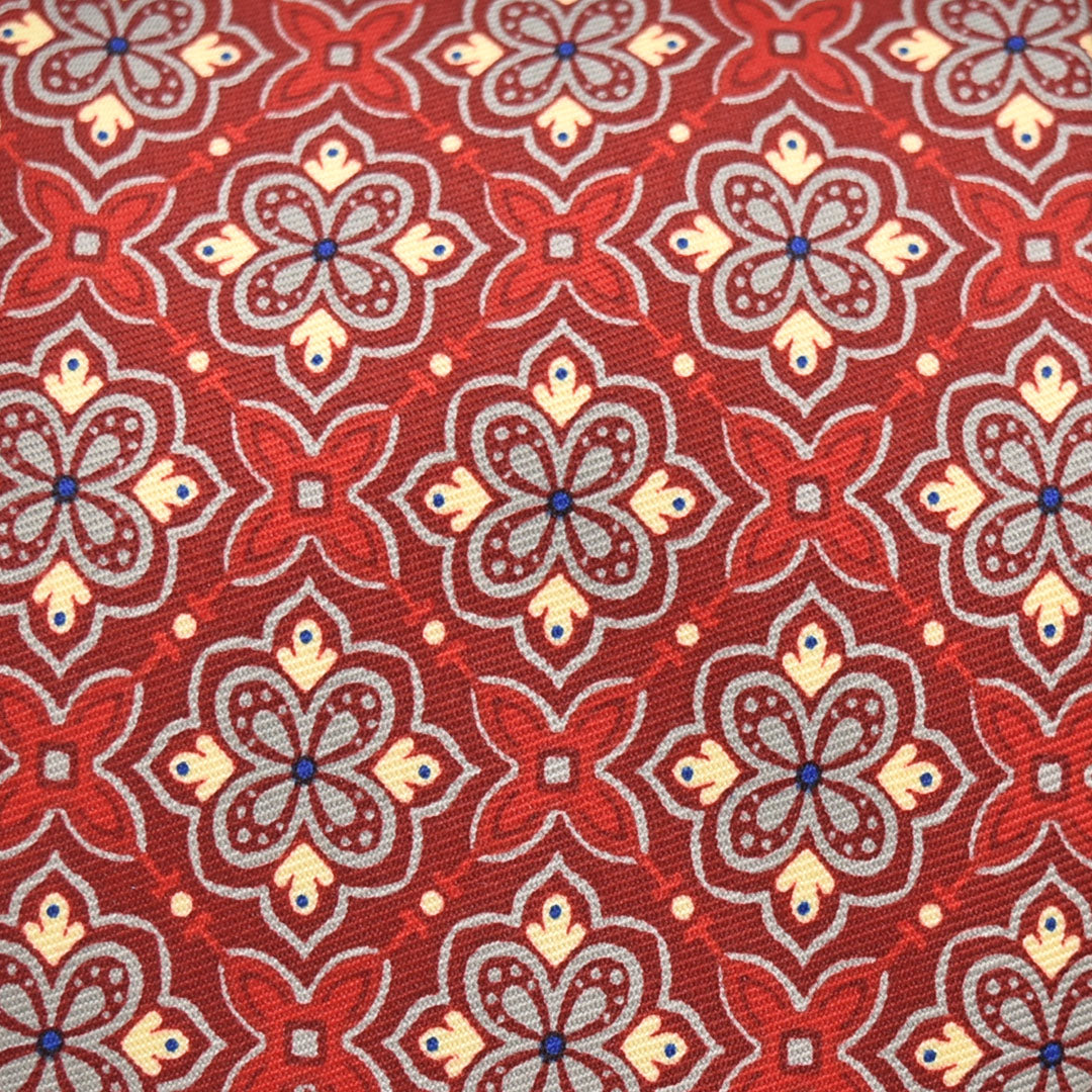 Close-up of a red fabric with intricate floral pattern