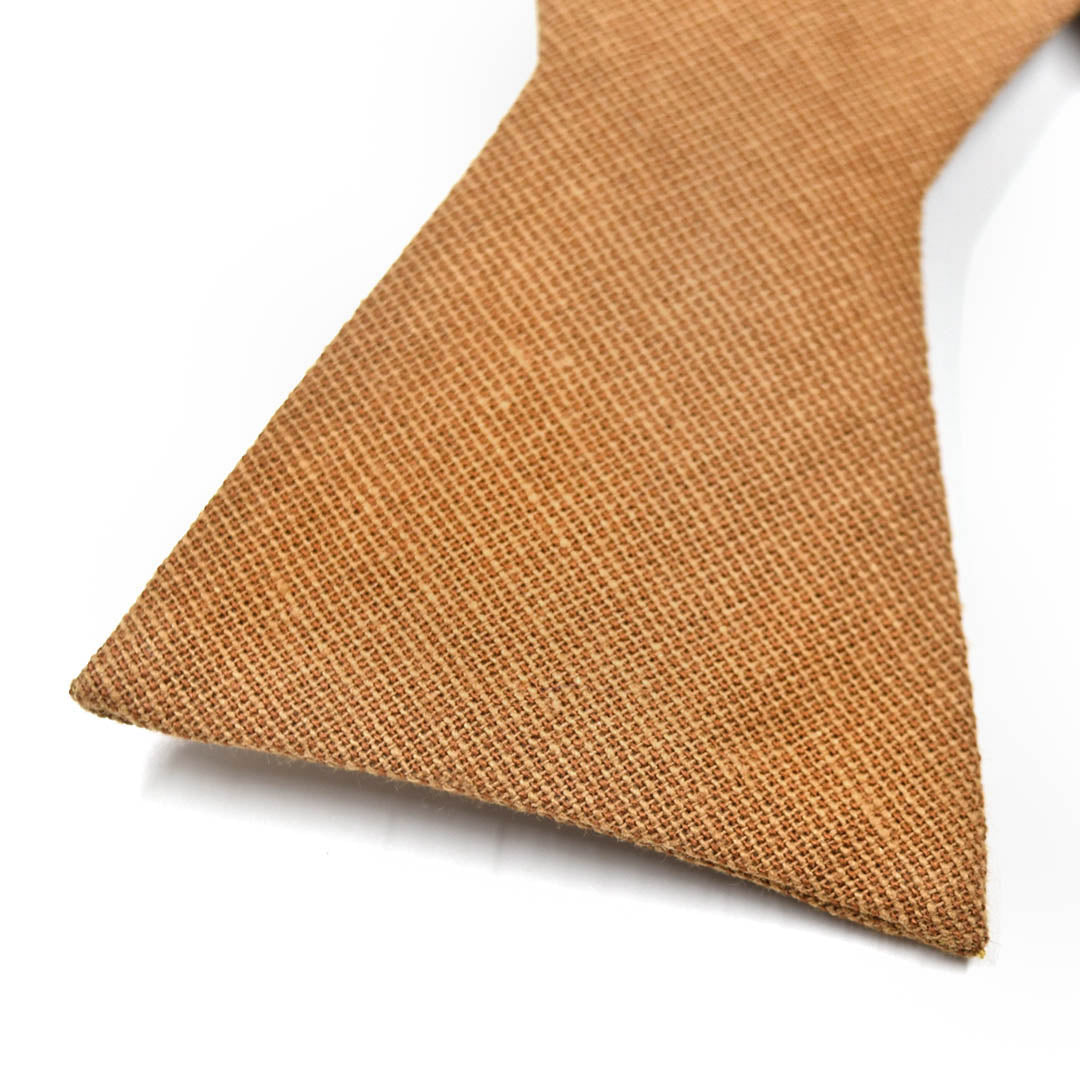 Brown textured bow tie on a white background