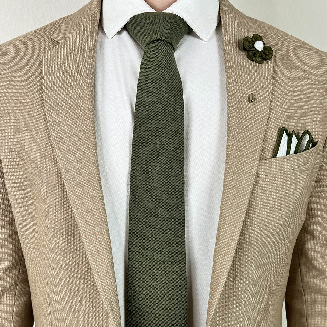 Kid wearing the solid olive pre-tied kids tie with a tan suit and white shirt for a wedding look.