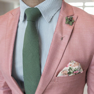 Solid Olive Tie set over a pink suit