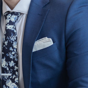 White Border Linen pocket square in a blue suit pocket