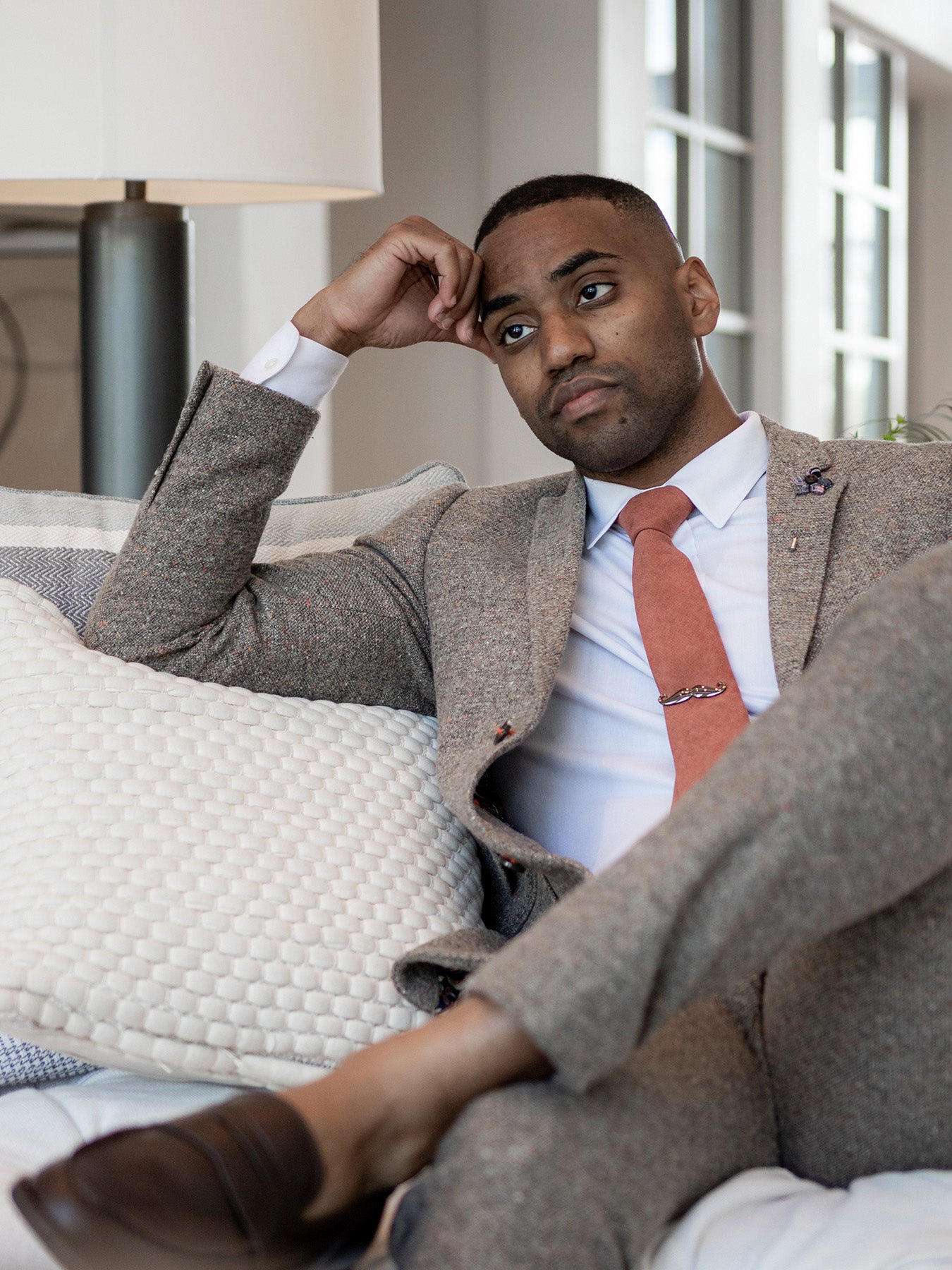 Art of The Gentleman Man wearing suit and tie sitting on a couch