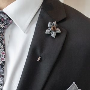 Wildflower Grey Lapel Pin on a black suit lapel