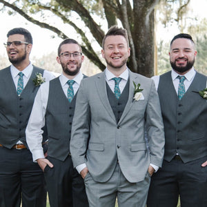 4 men wearing paisley teal ties and grey suit for a wedding